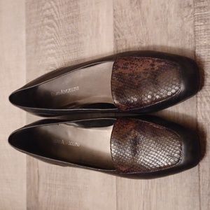 Enzo Angiolini black leather shoes with snakeskin print toes.